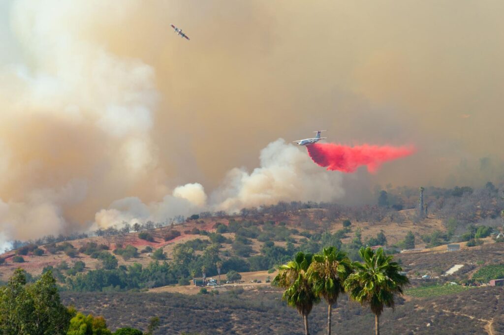 This photo of an airplane dropping fire retardant to battle flames in California is making the point that we need natural climate solutions like wildfire mitigation treatments (i.e. thinning and prescribed burns) to safeguard forests from catastrophic mega fires in the future.